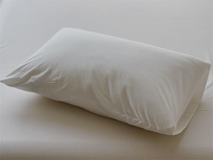 Comfort pillow with breathable cover and shape-retaining filling