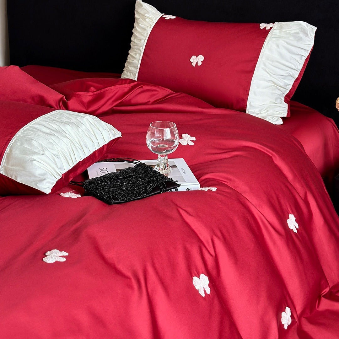 Luxurious cotton satin bedding set with embroidered bows and ruffle details