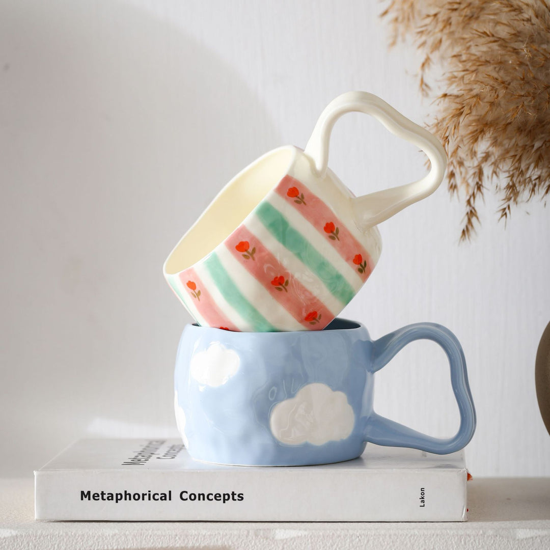 Ceramic mug with hand-painted stripes and flower design