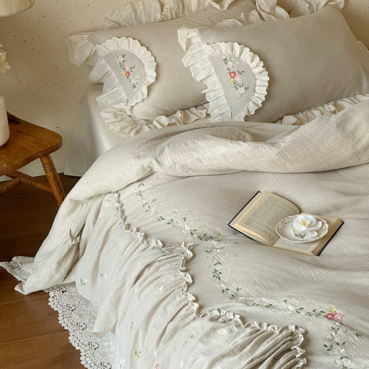 Linen bedspread in country house style with embroidered ruffle and lace edge