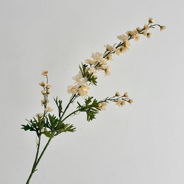 Artificial flower branch with intricately detailed red flowers