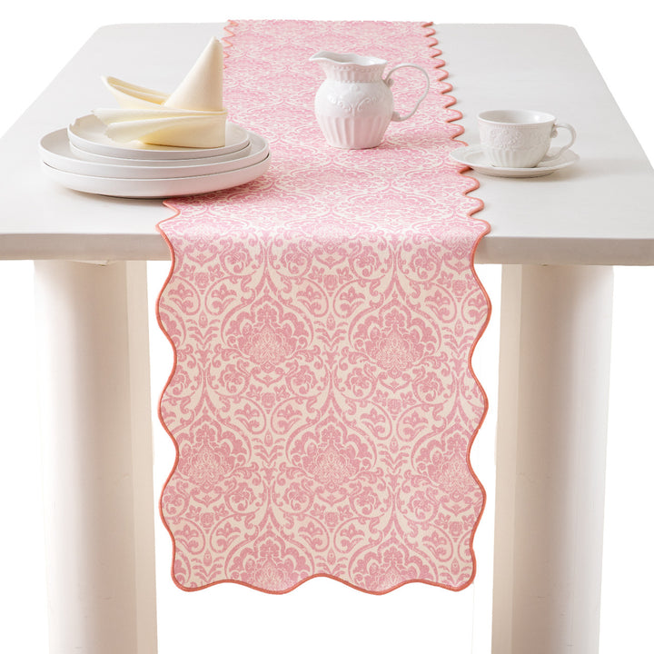 Elegant table runner with wavy hem and baroque damask pattern