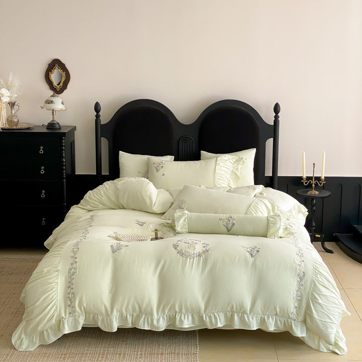 Premium bed linen set made of cotton percale with fine ruffle trim and embroidered calla motifs