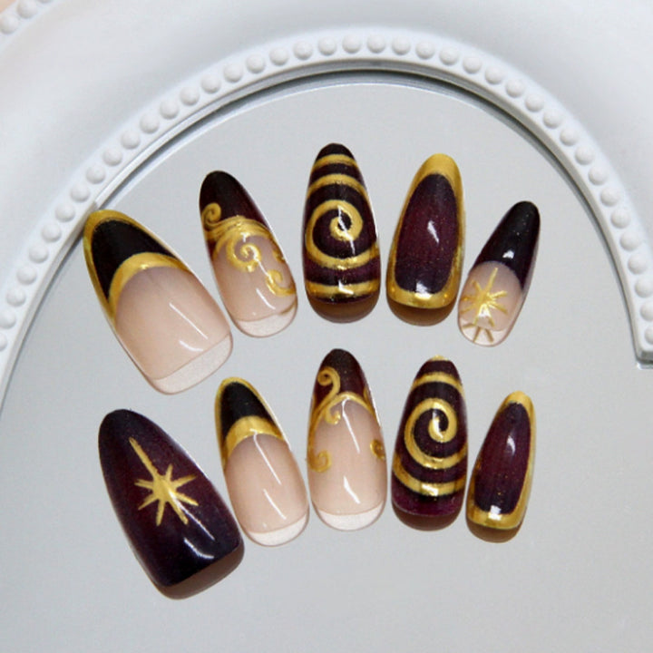 Acrylic nail set with elegant spiral patterns and glamorous golden accents Kalsten