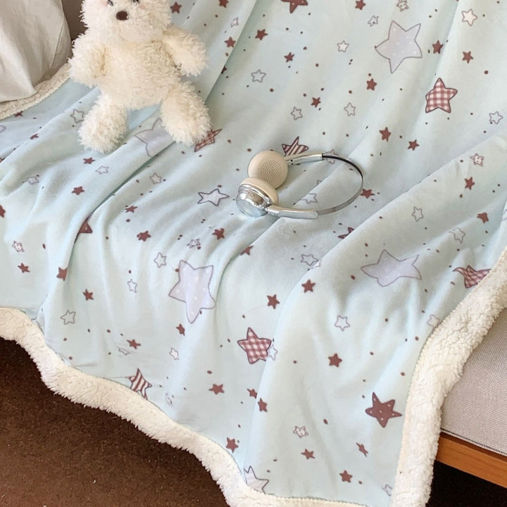 Reversible fleece blanket with cartoon cat design and teddy lining
