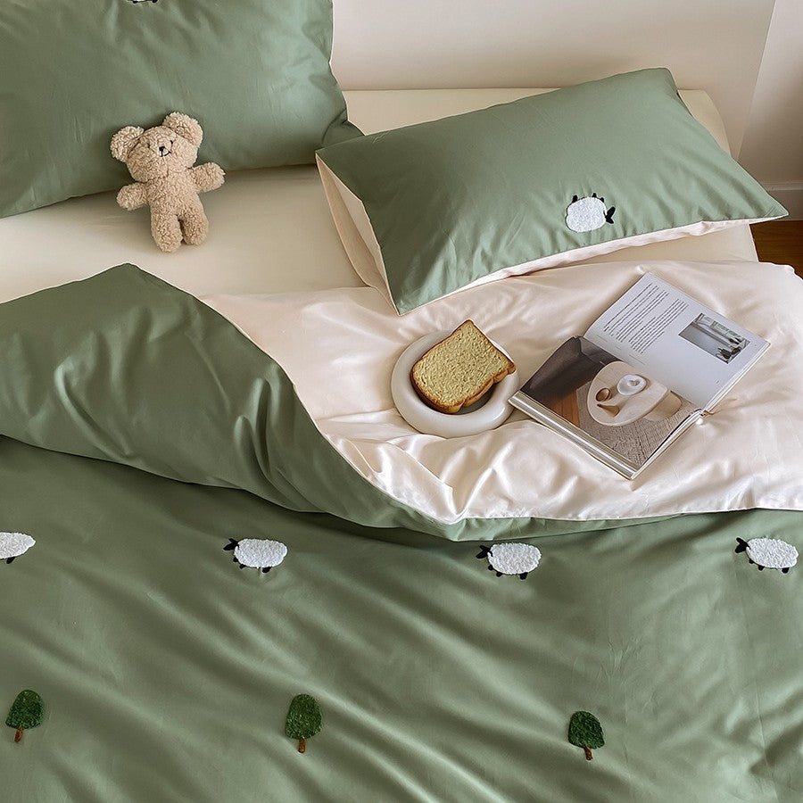 Reversible cotton satin duvet cover set with embroidered sheep and tree appliqués