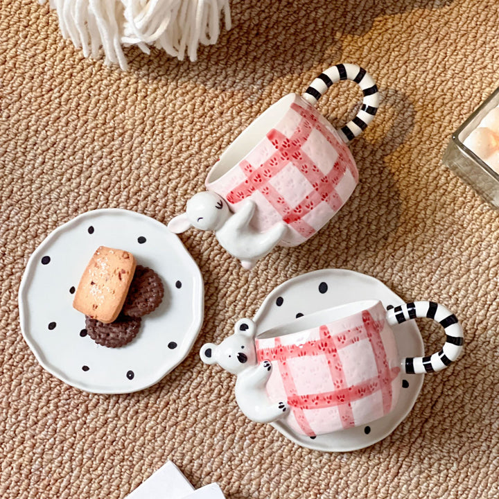 Playful ceramic cup set with koala relief handle and matching saucer