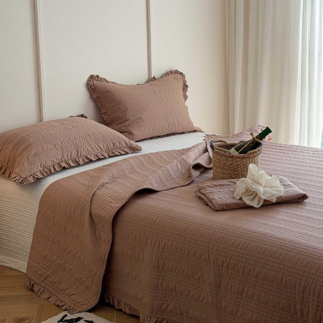 Quilted bedspread with frill and fine line quilting made of cotton blend fabric