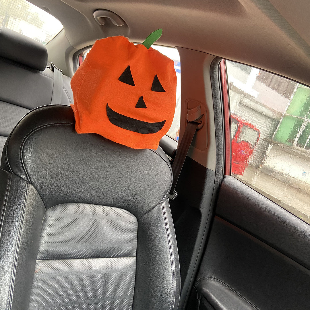 Plush decorative pillow with pumpkin face