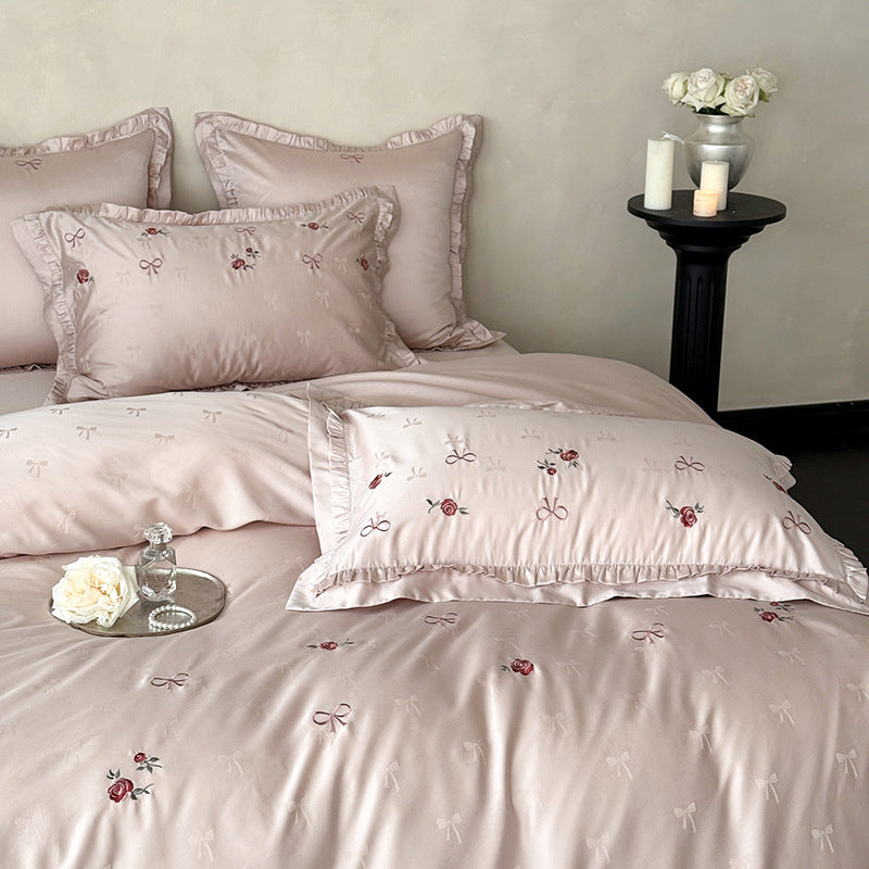 Luxurious satin bedding set with delicate floral embroidery and ruffles