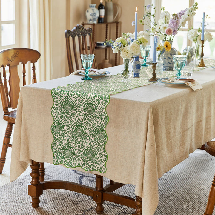 Elegant table runner with wavy hem and baroque damask pattern