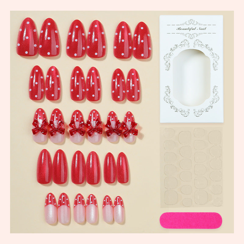 Nail set with playful red polka dots and bow accents Kalsten