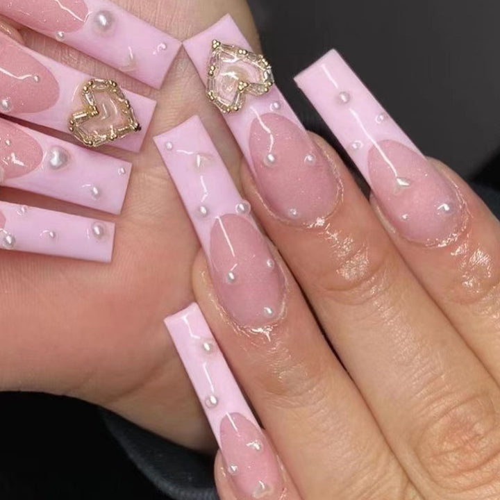 Artistic nail art with heart and pearl accents Kalsten