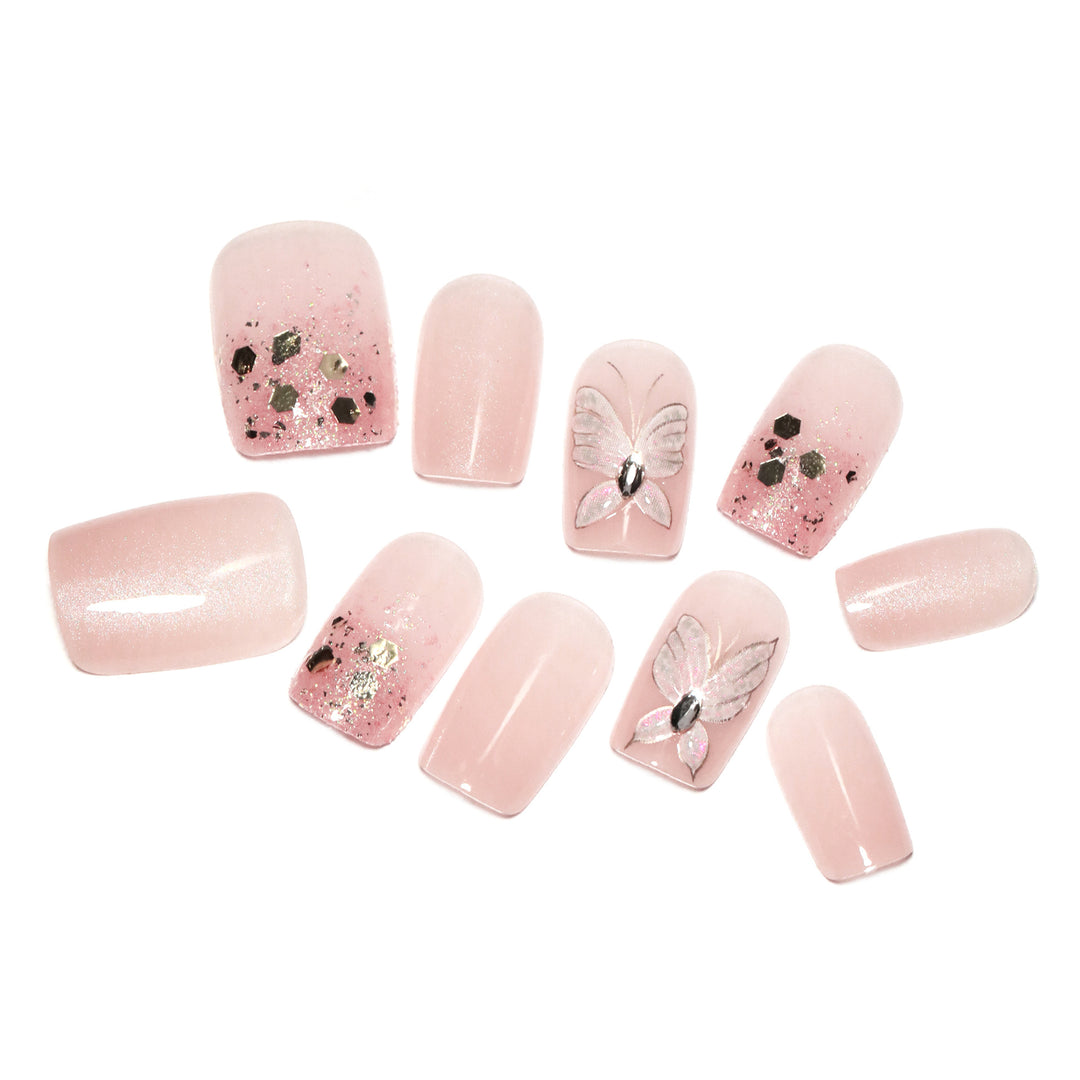 Artful nail art with butterfly designs and glitter accents Kalsten