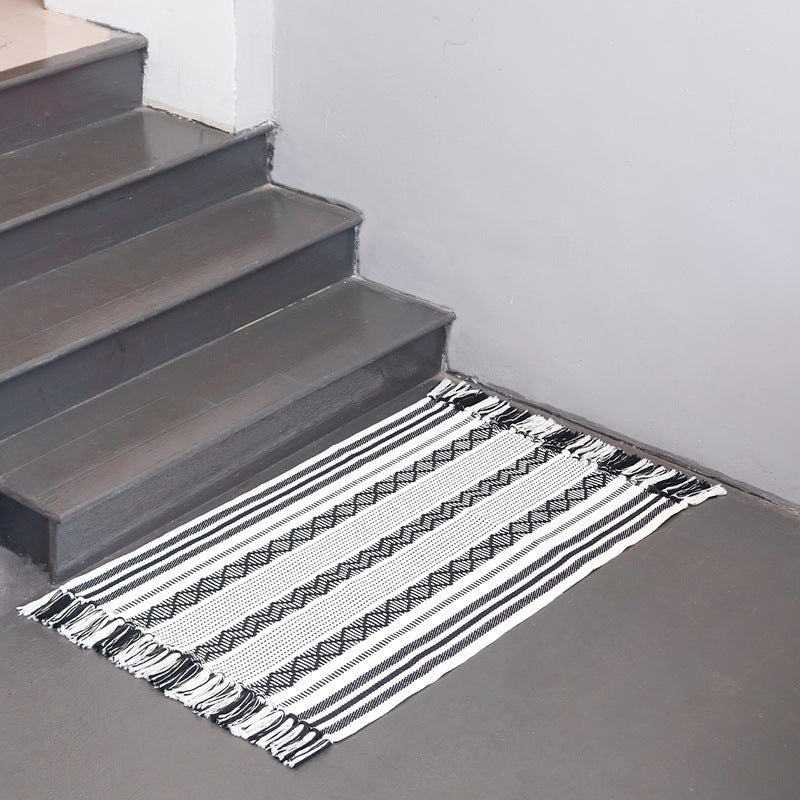Handwoven cotton runner with low pile, fringes, and geometric stripe pattern