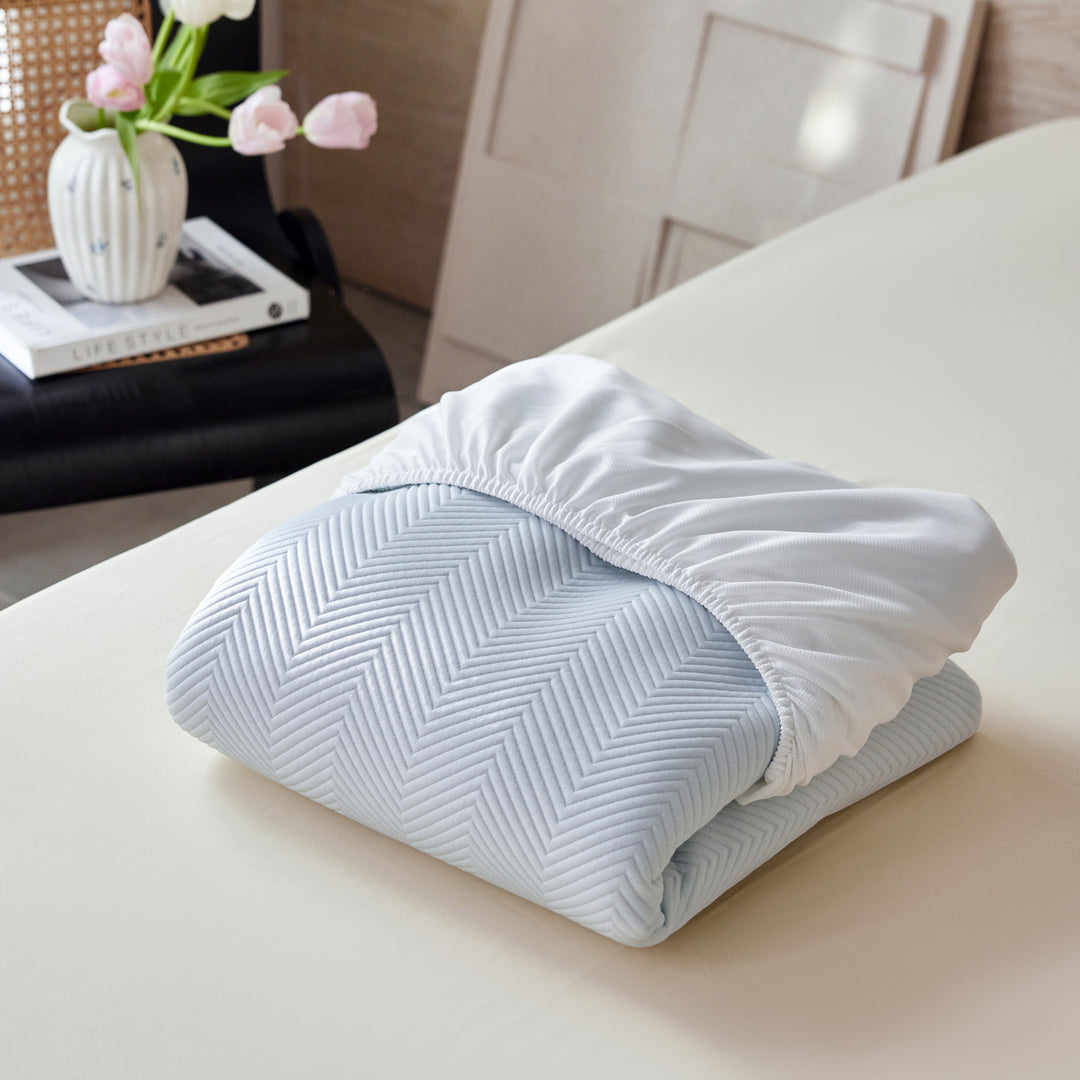 Breathable mattress topper with non-slip bottom and moisture-regulating structure