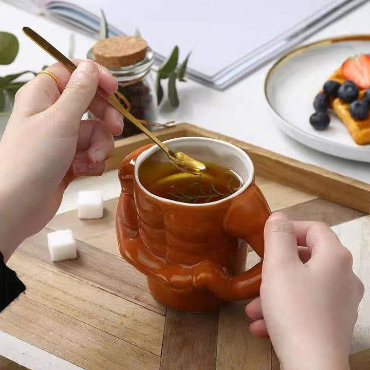 Ceramic mug in torso shape with muscular body and ergonomic handle