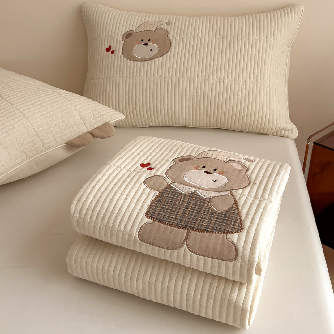 Quilted mattress topper with bunny applique and non-slip bottom