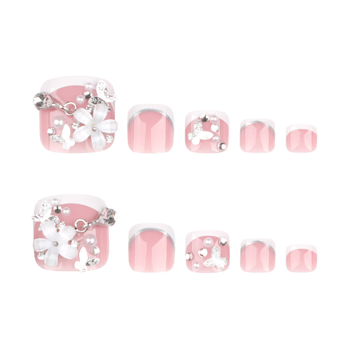 Artful toenail design with elegant flower and glitter accents Kalsten