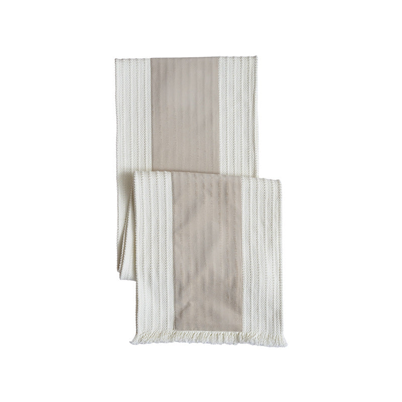 Woven table runner with contrasting center stripe, textured waffle look and decorative fringes