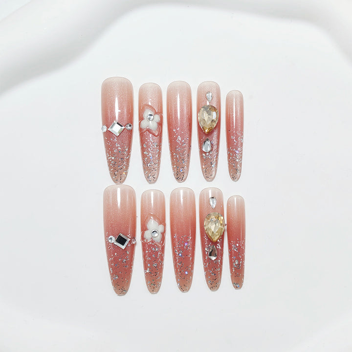 Artificial nail set with glitter and flower accents Kalsten