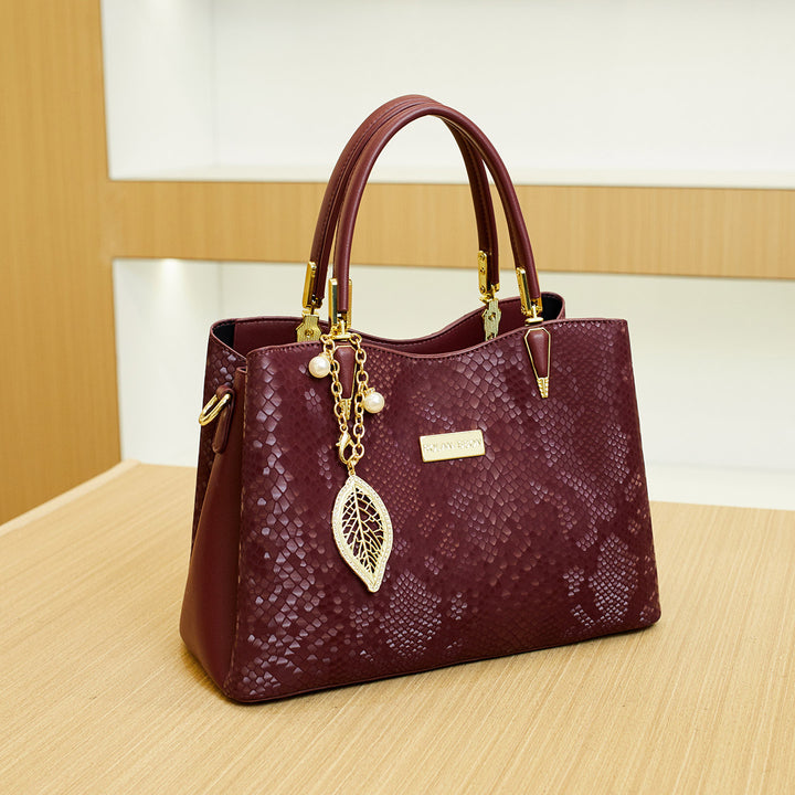 Elegant Designer Handbag with Decorative Charm