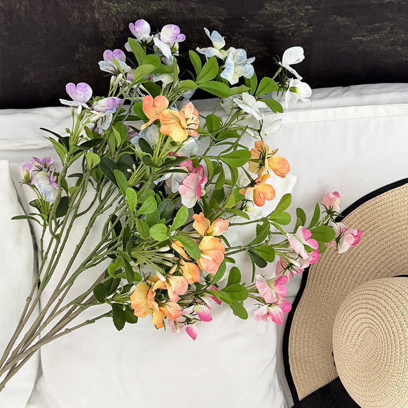Artificial flower branch with vibrant pink flowers