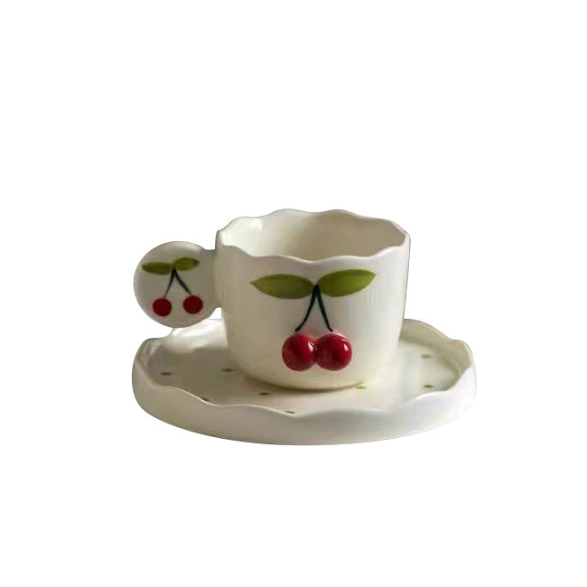 Hand-shaped espresso cup with wavy edge, round handle plate and applied cherry relief