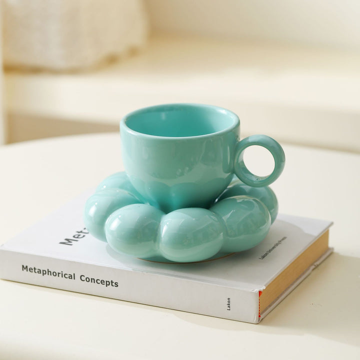 Ceramic mug with sculptural bubble saucer
