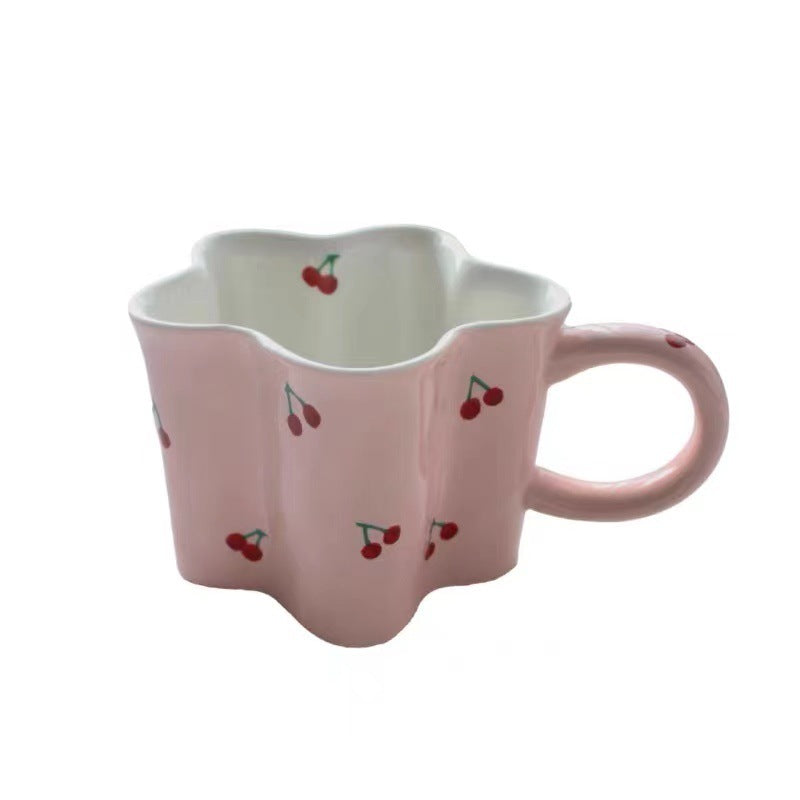 Ceramic coffee mug with flower-shaped wavy rim, illustrative banana decor and ergonomic handle