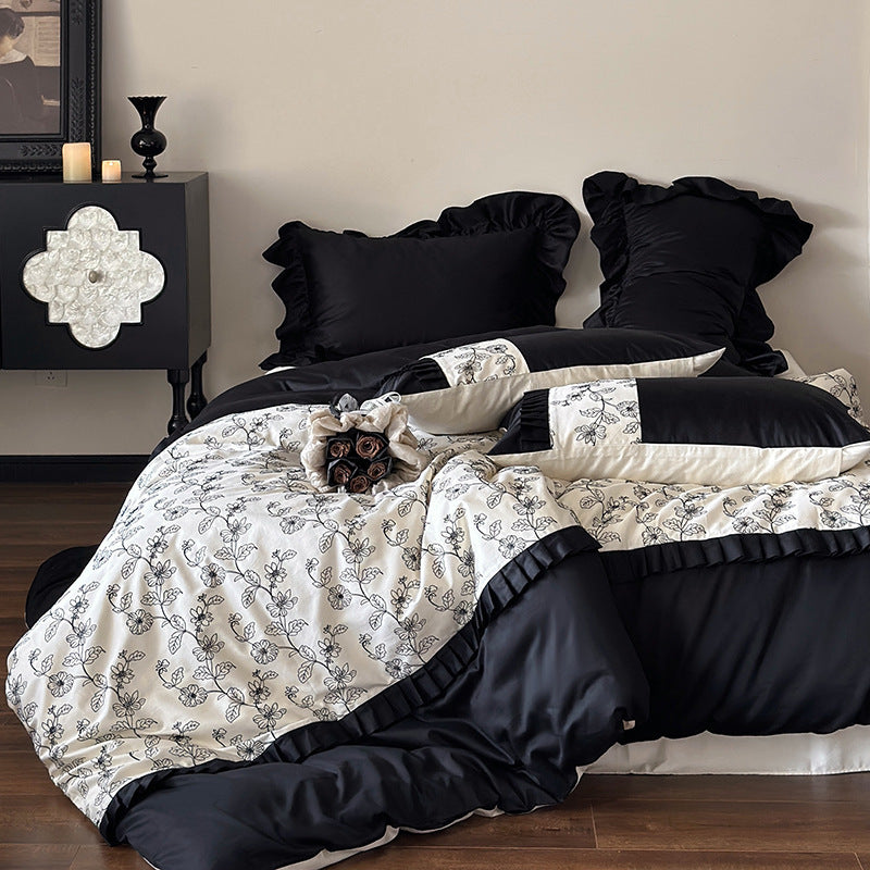 Luxurious cotton satin bedding set with ruffles and delicate floral embroidery