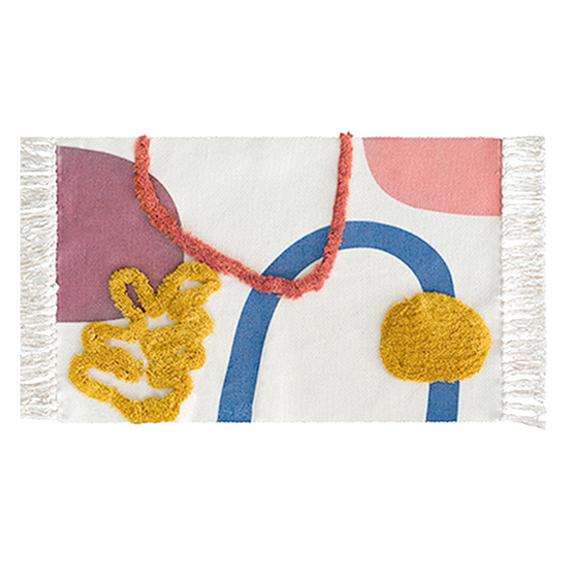 Hand-tufted bathroom mat with fringes, decorative dot-and-dash pattern and non-slip backing Kalsten