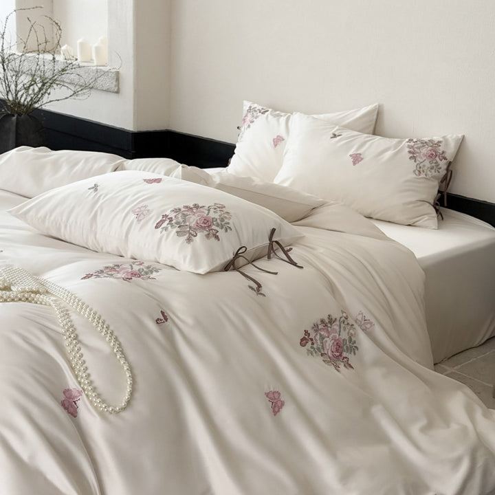 Silky-matte satin bedding set with embroidered rose bouquets and ties