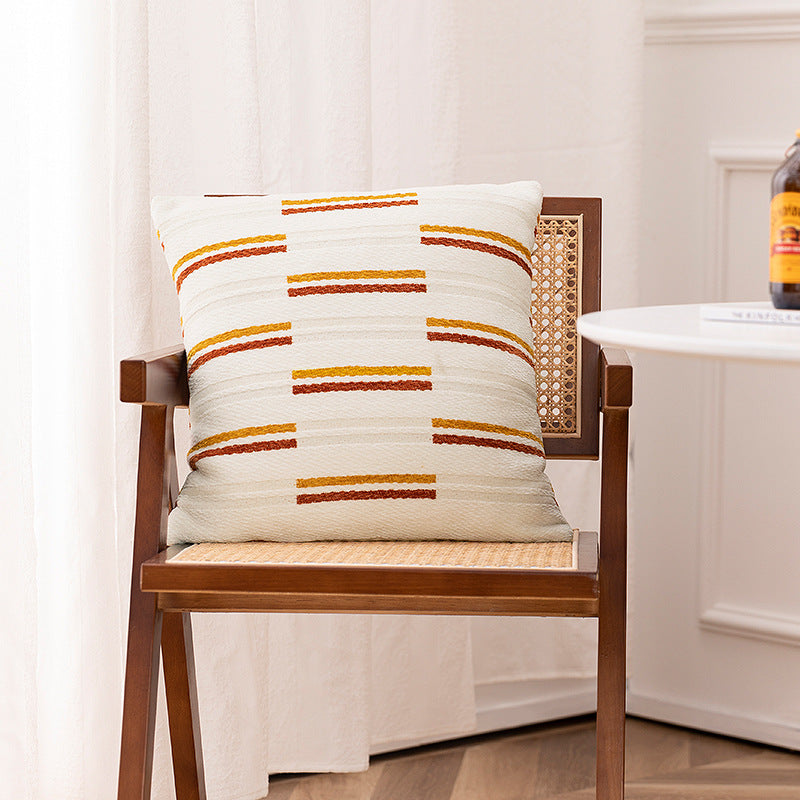 Woven cushion cover with graphic ethnic pattern and contrasting borders