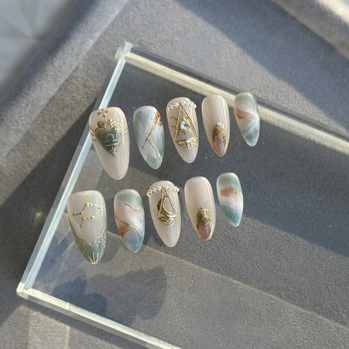 Artistic Press-On Nail Art Set with Celestial and Gem Accents