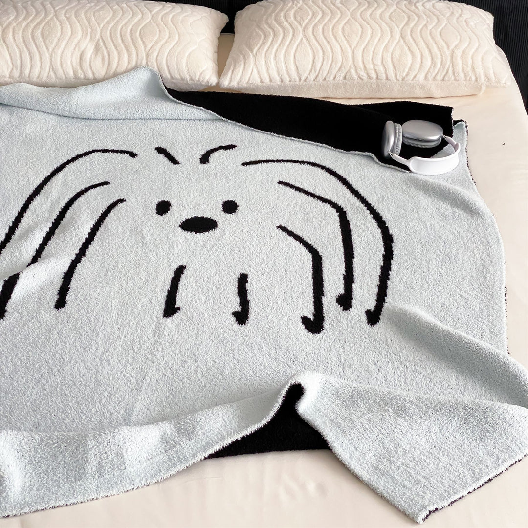 Reversible cuddly blanket made of terry cloth with decorative dog motif