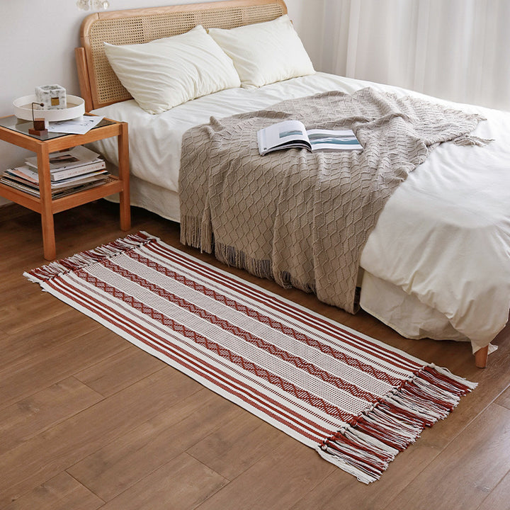 Handwoven cotton runner with low pile, fringes, and geometric stripe pattern