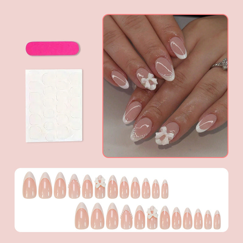 Acrylic nail set with elegant floral embellishments and trendy French tip Kalsten