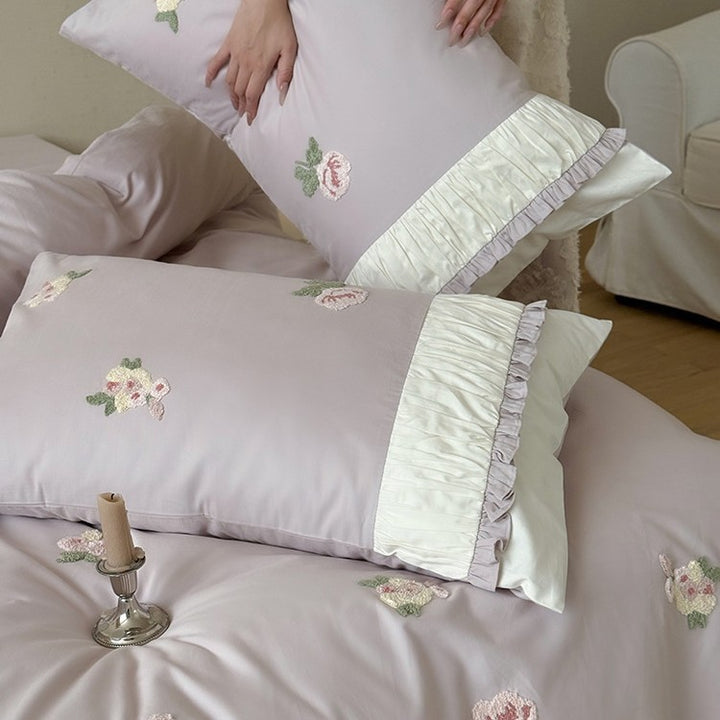 Luxurious cotton bedding set with delicate rose embroidery and ruffles