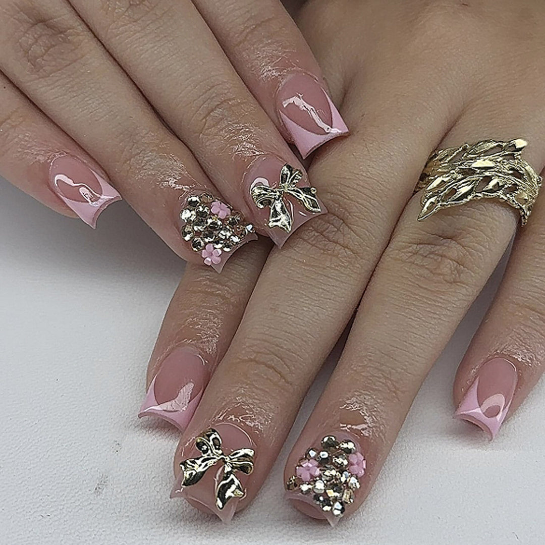 Artful nail art with glitter accents and bow decoration Kalsten