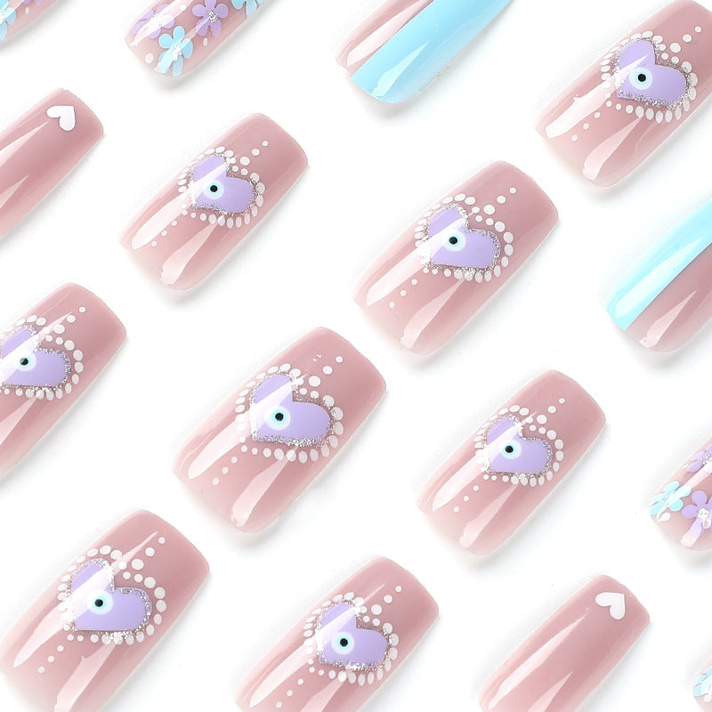 Artful nail art with floral accents and glitter embellishments Kalsten