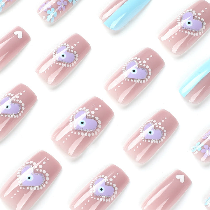 Artful nail art with floral accents and glitter embellishments Kalsten