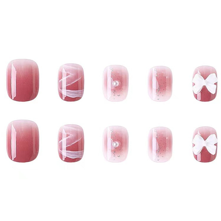Glamorous nail art with pearl and bow accents Kalsten