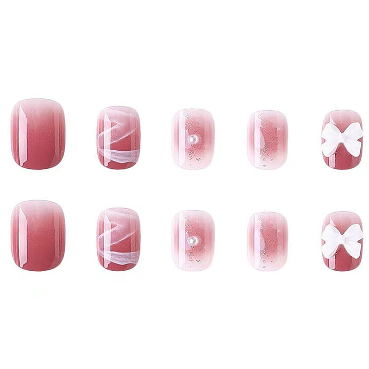 Glamorous nail art with pearl and bow accents Kalsten