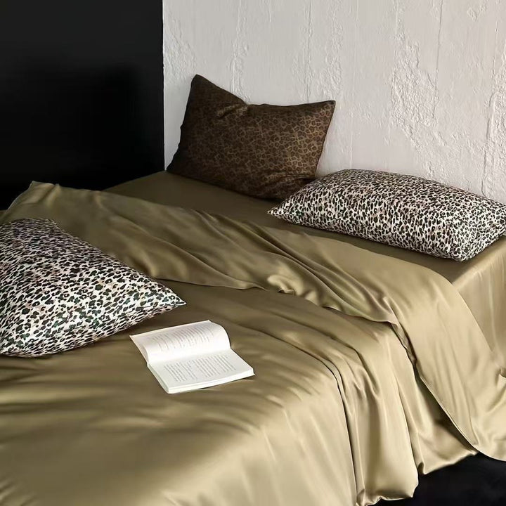 Satin bedding set with a silky sheen, smooth drape, and animal print pillows