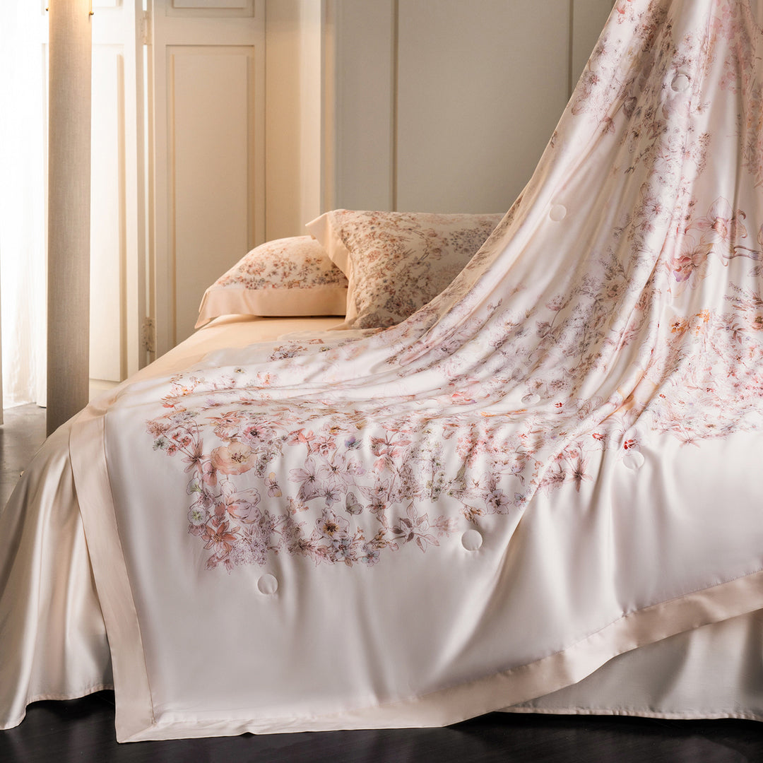 Luxurious cotton satin bed linen set with delicate floral print and quilted bedspread