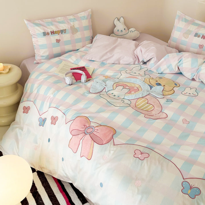 Playful cotton bedding set with embroidered bunny and cherry motif including decorative pillow