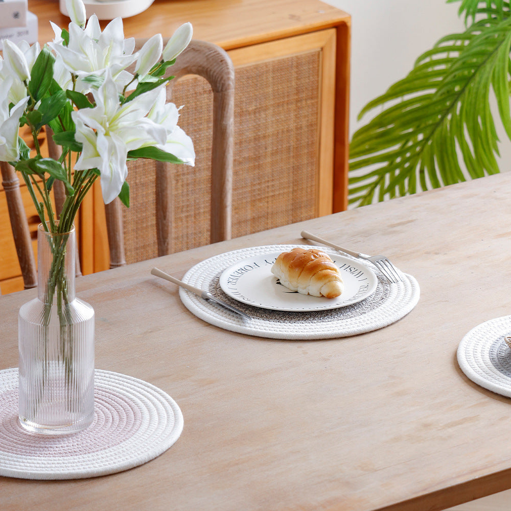 Round handwoven table placemat made of cotton yarn with structured spiral binding