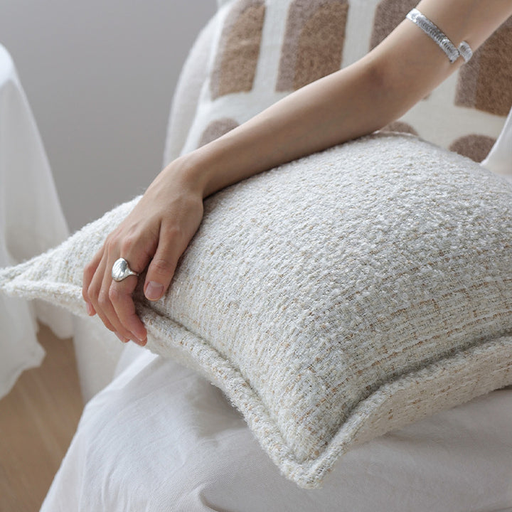 Square cushion cover made of textured bouclé blend with decorative piped seam Kalsten