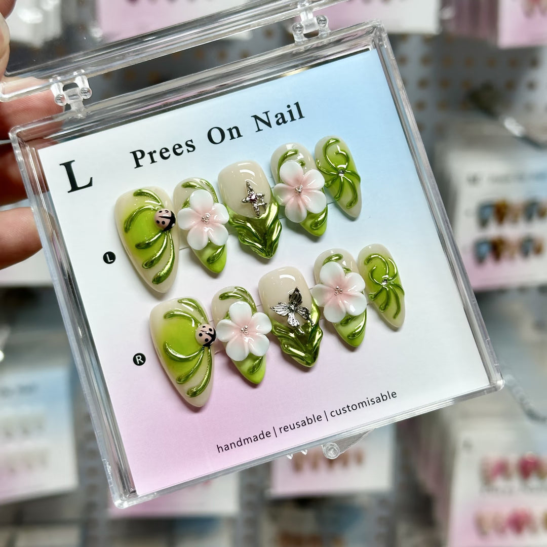 Artistic Press-On Nail Set with Floral and Green Accents